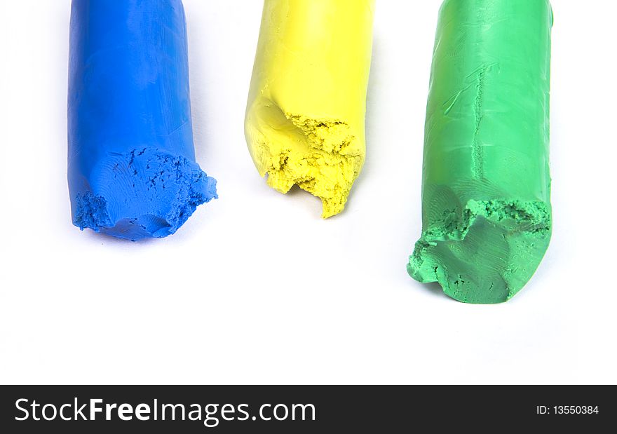 Colored plasticine on white background