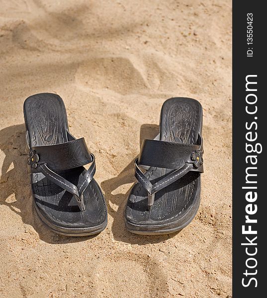 Pair of sandals on the beach