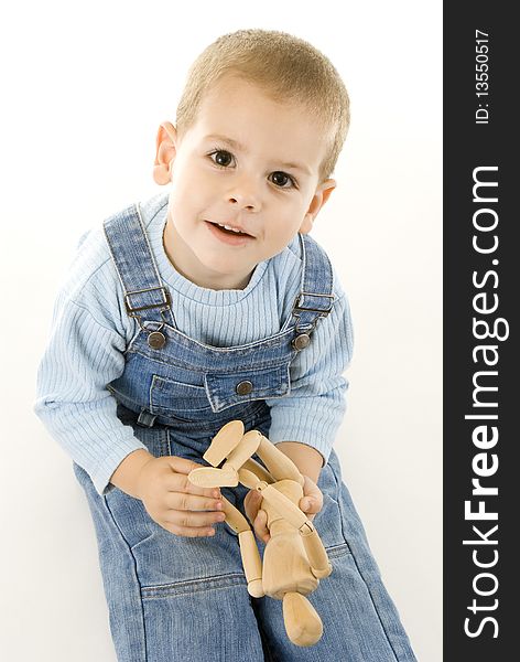 Happy boy playing and showing his wooden figurine