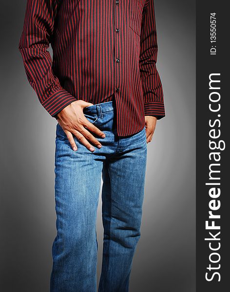 Beautiful blue jeans and red shirt wearing a model isolated on a gray background.