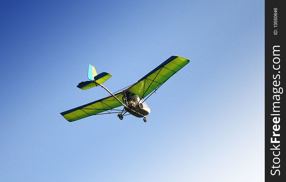 Motor gliding green flight in blue sky. Motor gliding green flight in blue sky