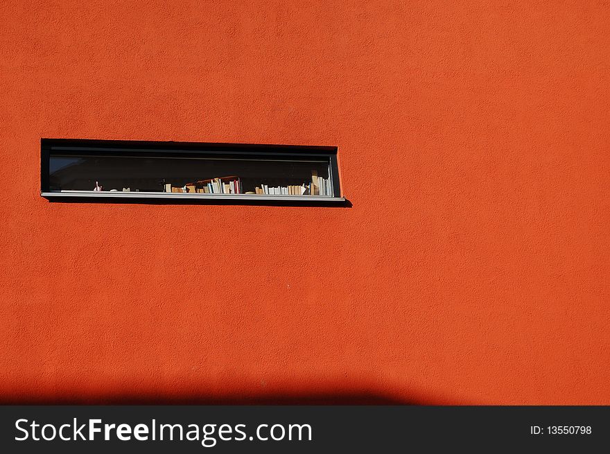 Modern window with books and a small shadow