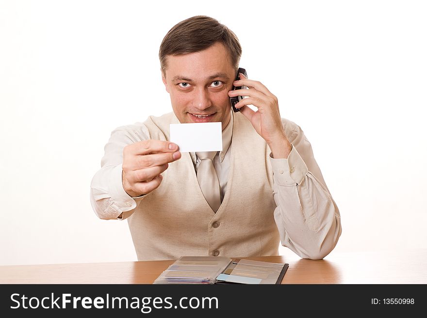 Businessman talking on the phone at the table on a white