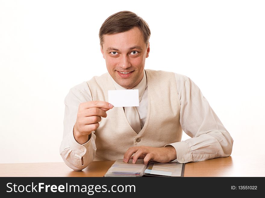 Handsome young businessman shows the business card on a white background