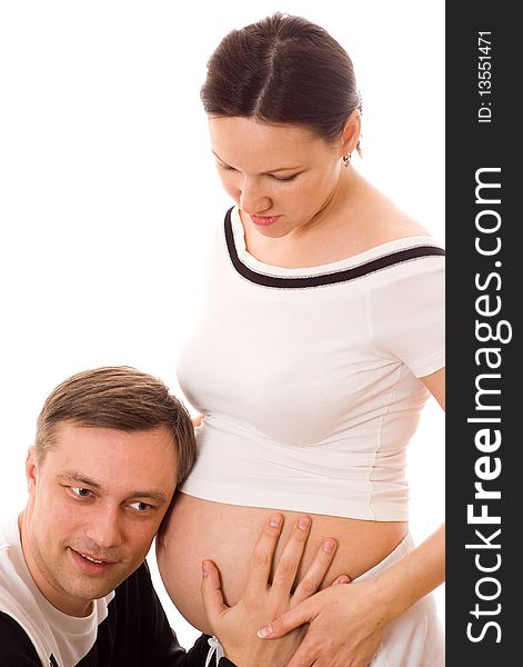 Young man leaned against the stomach of a pregnant wife on a white background