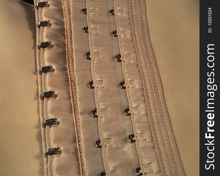 Eyelets and hooks used in girdles and in corsets