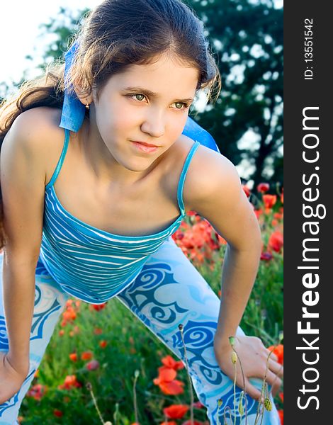 Portrait teen girl with poppy on nature