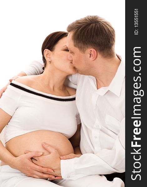 Man with his pregnant wife on a white