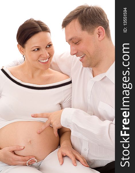 Man with his pregnant wife were sitting on a white