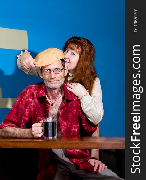 Red woman and man in cap with mug