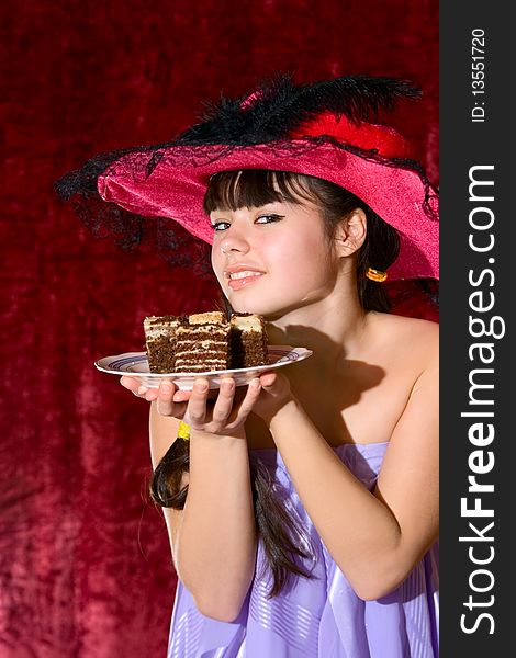 Lovely teen girl in dress and hat with cake. Lovely teen girl in dress and hat with cake