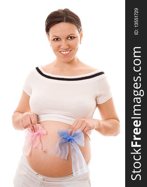 Beautiful pregnant woman holding a bow on his stomach on a white background