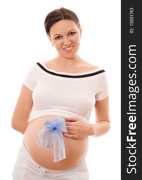 Beautiful pregnant woman holding a bow on his stomach on a white. Beautiful pregnant woman holding a bow on his stomach on a white