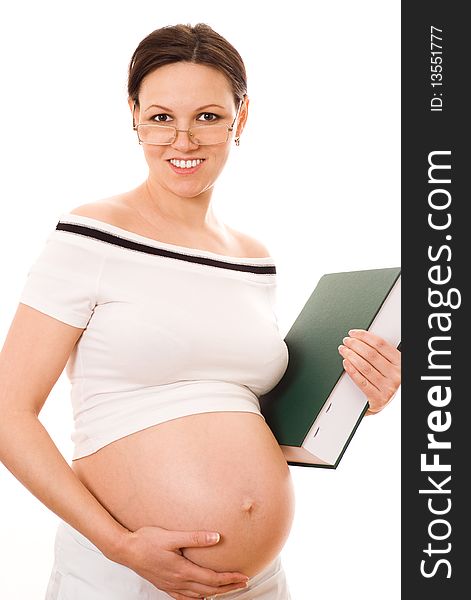 Beautiful pregnant woman holding a green book on a white background