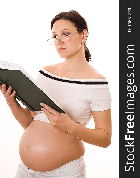 Beautiful pregnant woman holding a green book