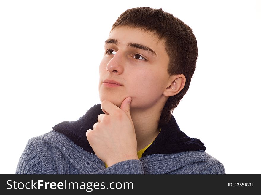 Handsome young man stands and thinks on a white background