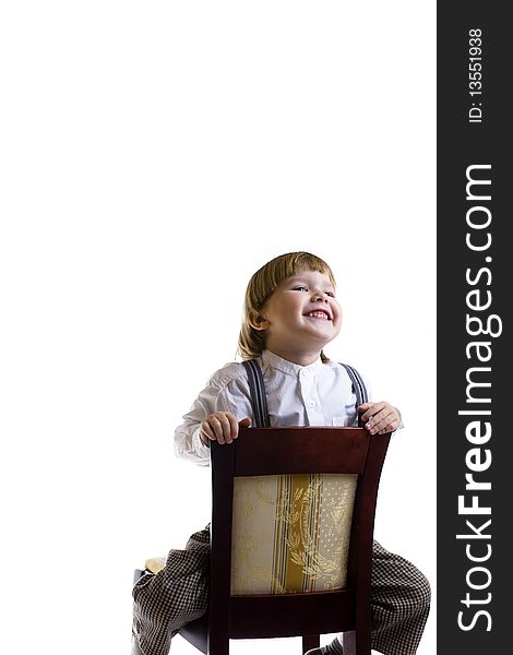 Boy sitting on chair laughing with copy space isolated. Boy sitting on chair laughing with copy space isolated