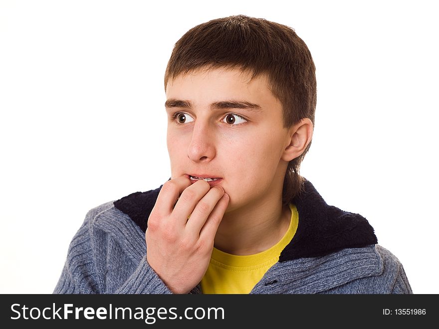 Teenager standing and thinking on a white background