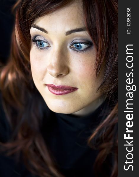 Closeup Portrait of handsome woman with blue eyes looking to the side