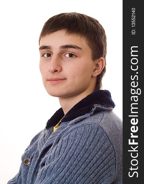 Teenager in a blue jacket standing on a white background