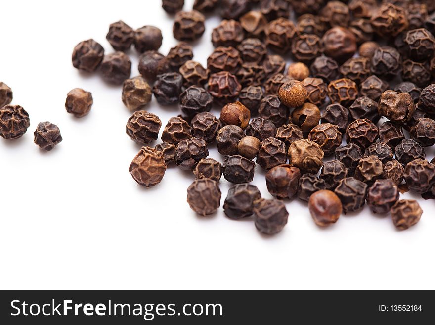 Close up of black peppercorns in isolated white background. Close up of black peppercorns in isolated white background