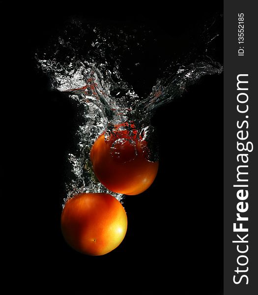 Red tomatoes in water