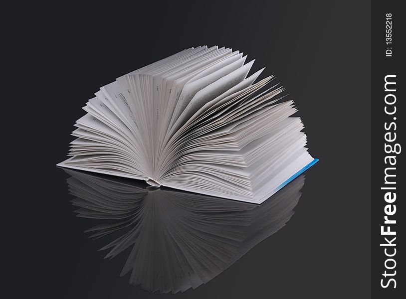 The open book on a dark background