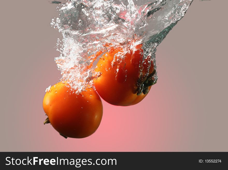 Isolated red tomatoes in water