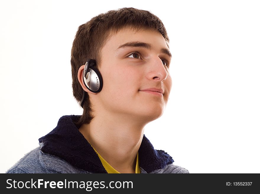 Beautiful teenager in a blue blouse with headphones on white background. Beautiful teenager in a blue blouse with headphones on white background