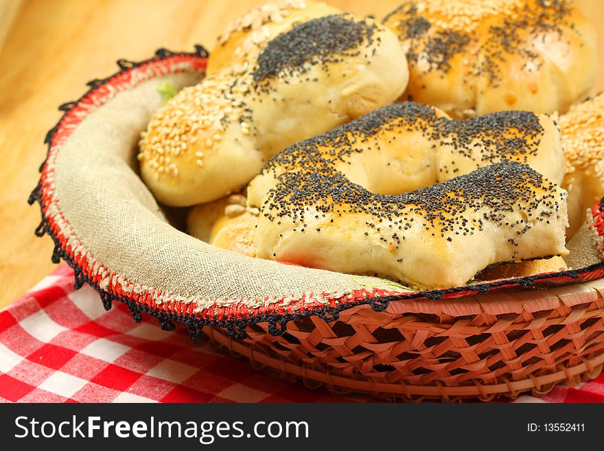 Fresh different kinds of bread rolls covered with seeds in basket. Fresh different kinds of bread rolls covered with seeds in basket.