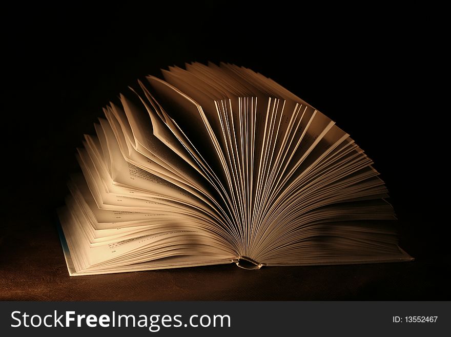 The open book on a dark background