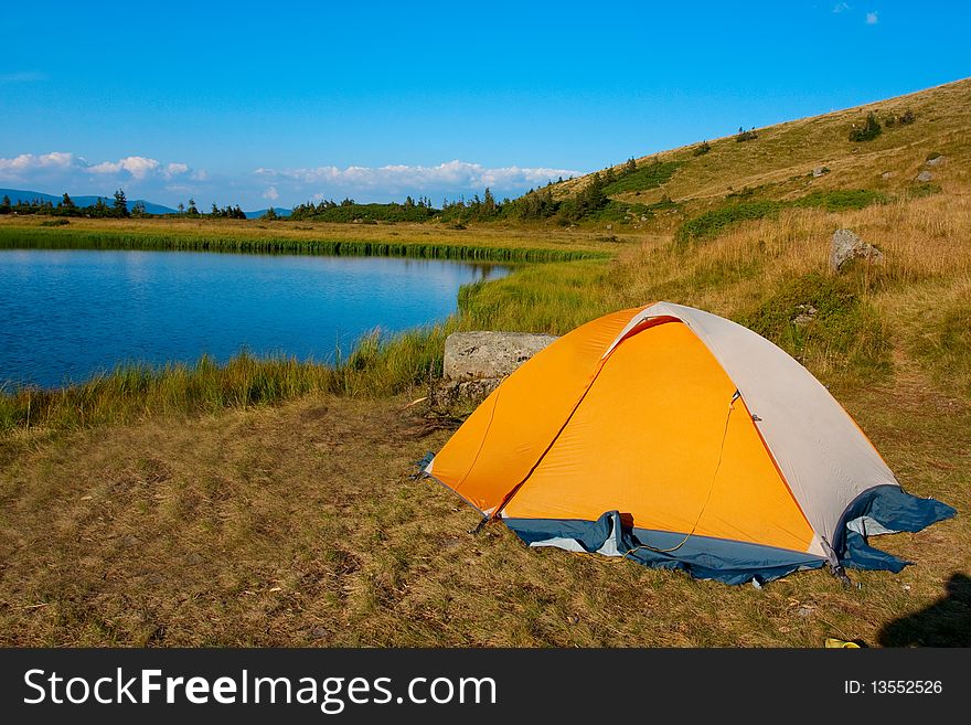 Orange tent in Carpathian mountain
