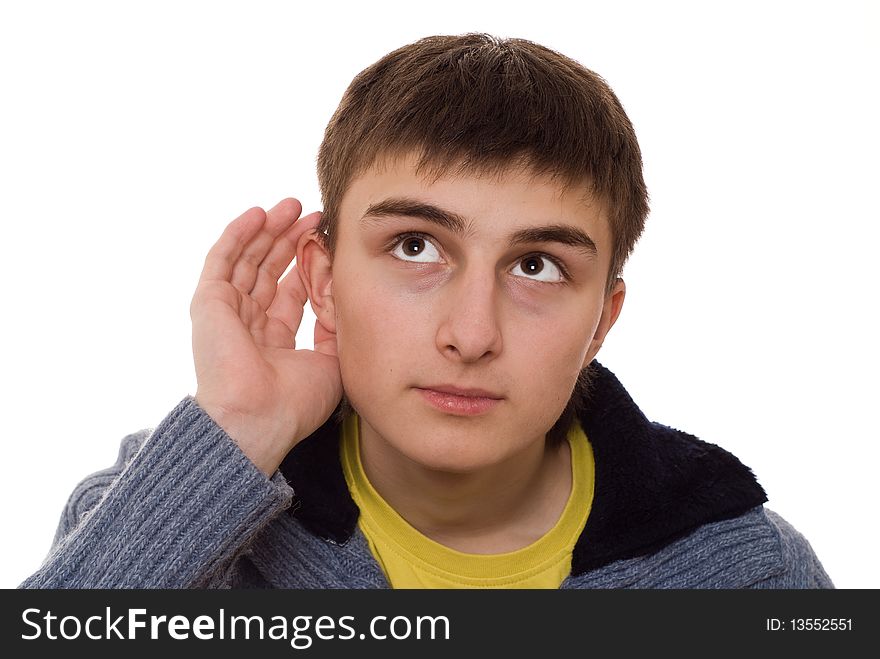 Beautiful teenager in a blue blouse listens on a white background. Beautiful teenager in a blue blouse listens on a white background