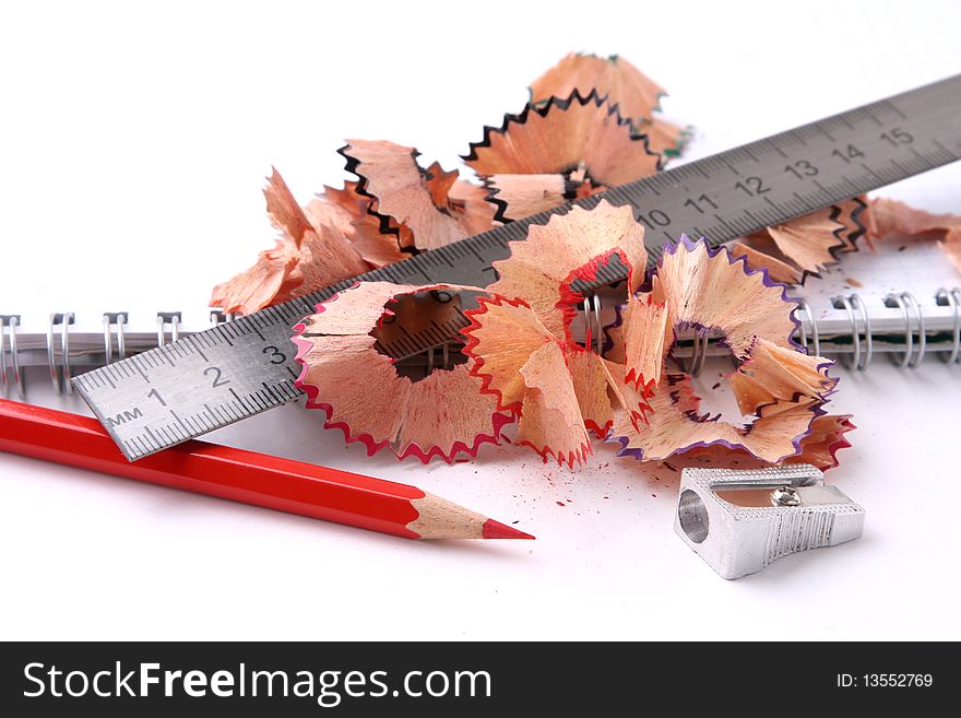 Open Spiral Notebook With Pencil And Sharpener.