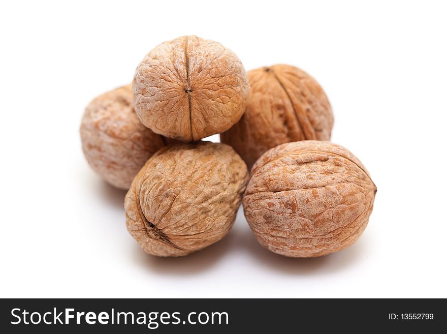 Close-up of a walnut against white background. Close-up of a walnut against white background