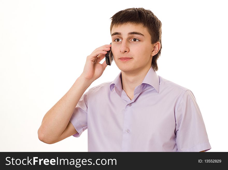 Handsome young student, talking on the phone on a white background