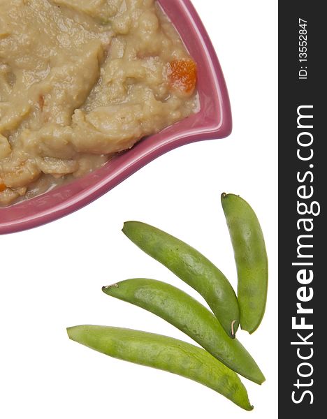 Split pea soup garnished with sugar snap peas.  Isolated on white with a clipping path.