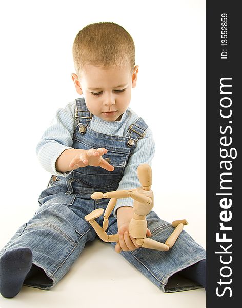 Happy boy playing and showing his wooden figurine