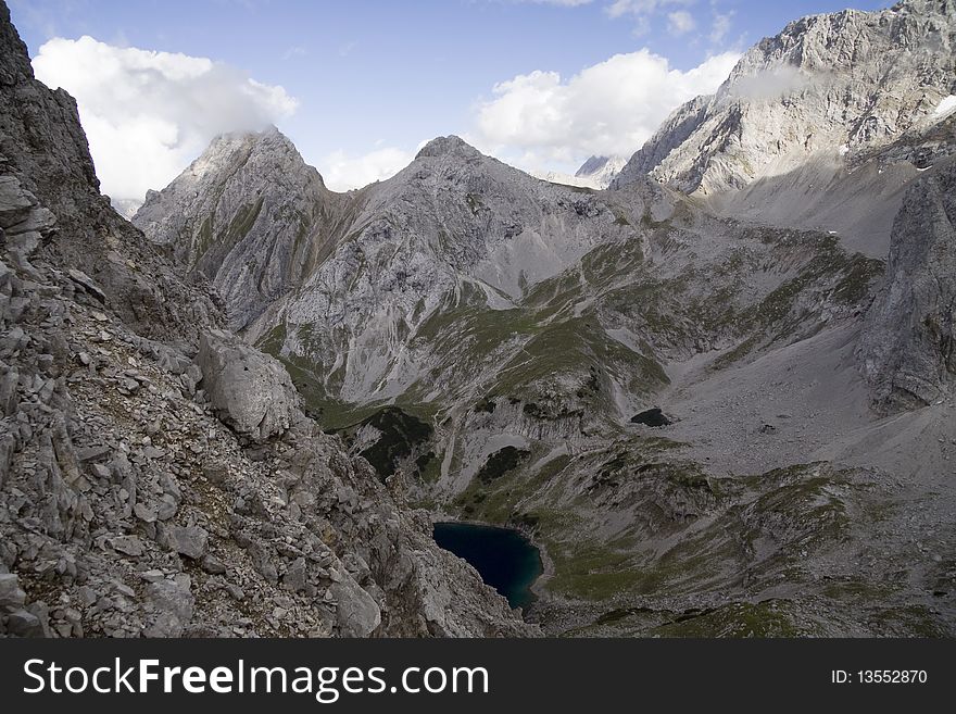 Photo is taken from the ridge between 2 peaks of Dragonkopf. On the back: Tajakopf peak and Dragonsee lake, Ehrwald, Tirol