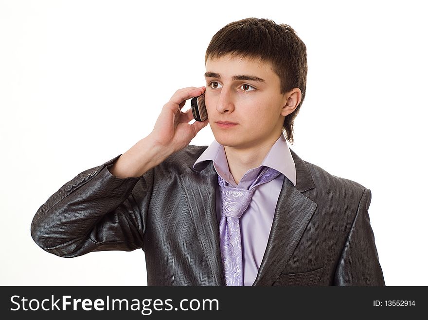 Handsome young businessman talking on the phone on a white