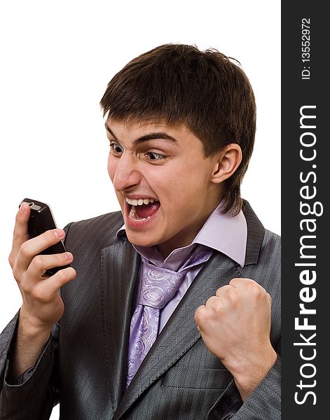 Angry young businessman talking on the phone on a white background