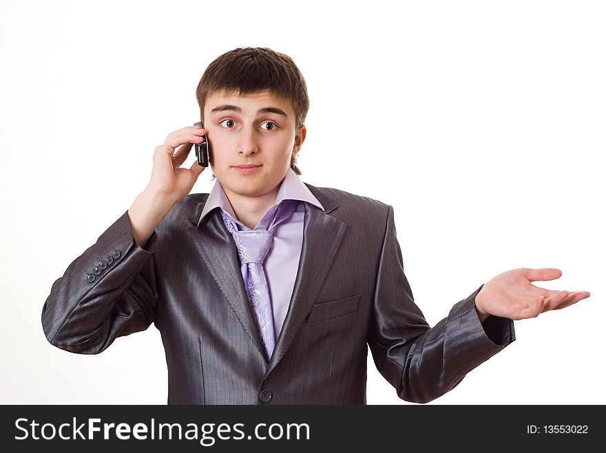 Handsome young businessman talking on the phone on a white background