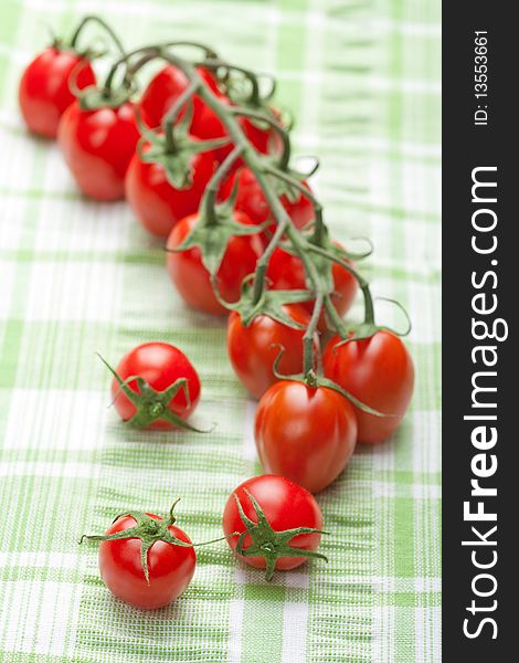 Ripe tomatoes over green cloth