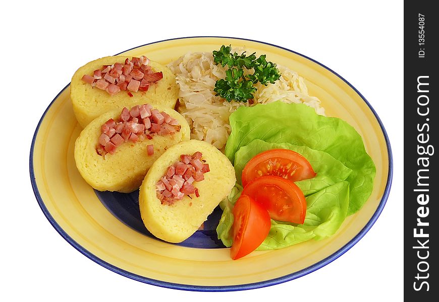 Plate of dumplings stuffed with meat and sauerkraut decorated with vegetables. Plate of dumplings stuffed with meat and sauerkraut decorated with vegetables