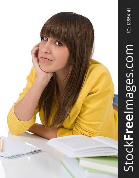 Student - Happy female teenager write homework with book on white background. Student - Happy female teenager write homework with book on white background