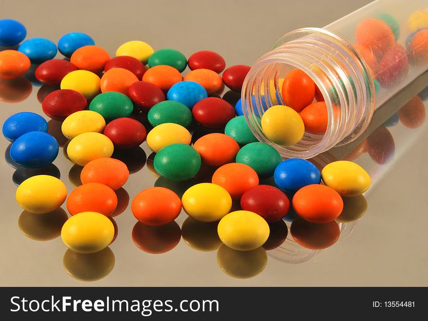 Colorful round candies on glass. Colorful round candies on glass