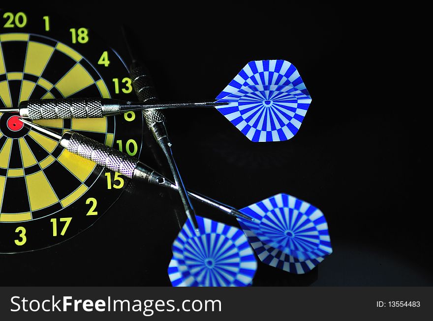 Dart and the dart board on the black background. Dart and the dart board on the black background