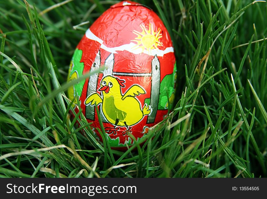 Chocolate egg placed in the grass so children can look for it. Chocolate egg placed in the grass so children can look for it
