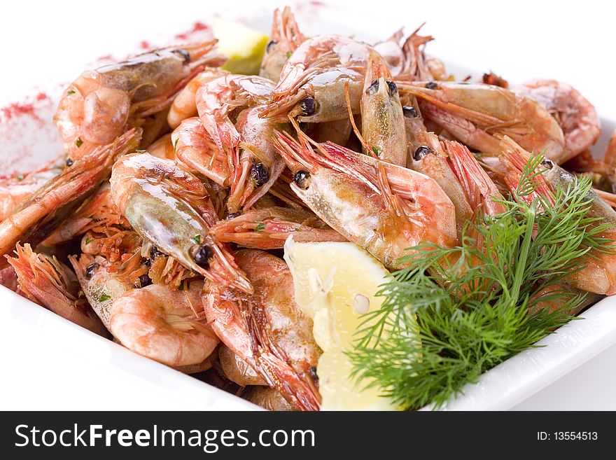 Shrimps with dill and lemon on white plate
