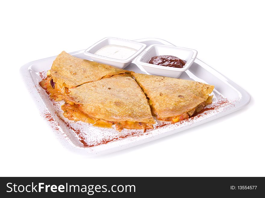 Quesadillas on whte plate with sauces